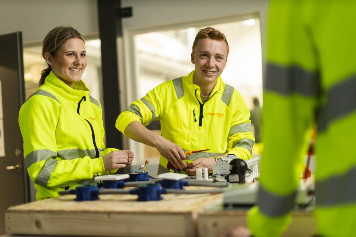 Två elever på el och energiprogrammet som arbetar i verkstaden