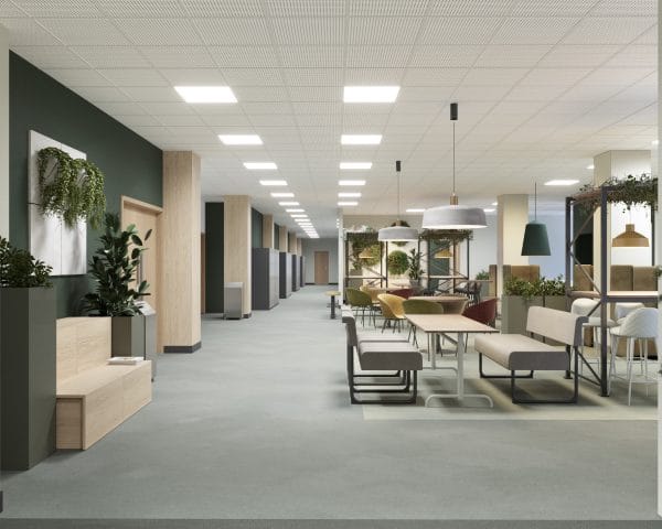 En lång korridor med öppna studieplatser och matsalsliknande bord. Rummet har moderna möbler i olika färger och gröna väggar dekorerade med växter. Taket är vitt med rutnätsmönster och innehåller infällda lampor.